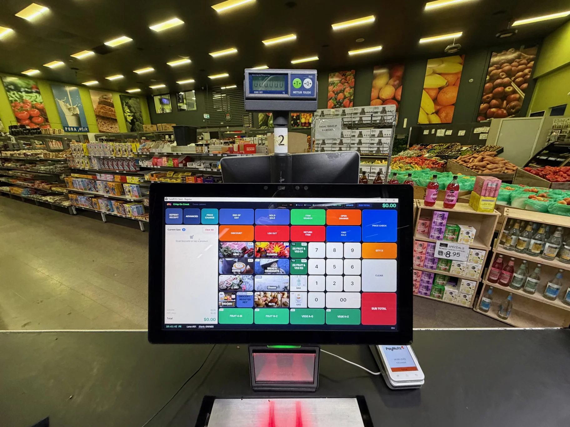 YieldPOS running at a Crisp on Creek checkout, with the shop's produce displays behind it